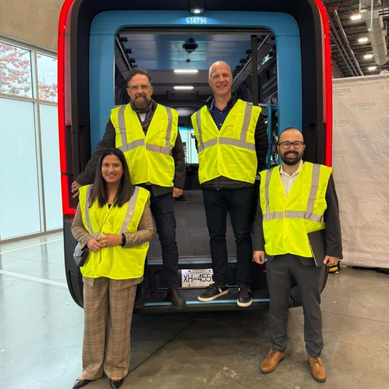 Members of the Evolution Fulfillment team check out Amazon's new sustainable electric delivery vehicles in Delta BC.