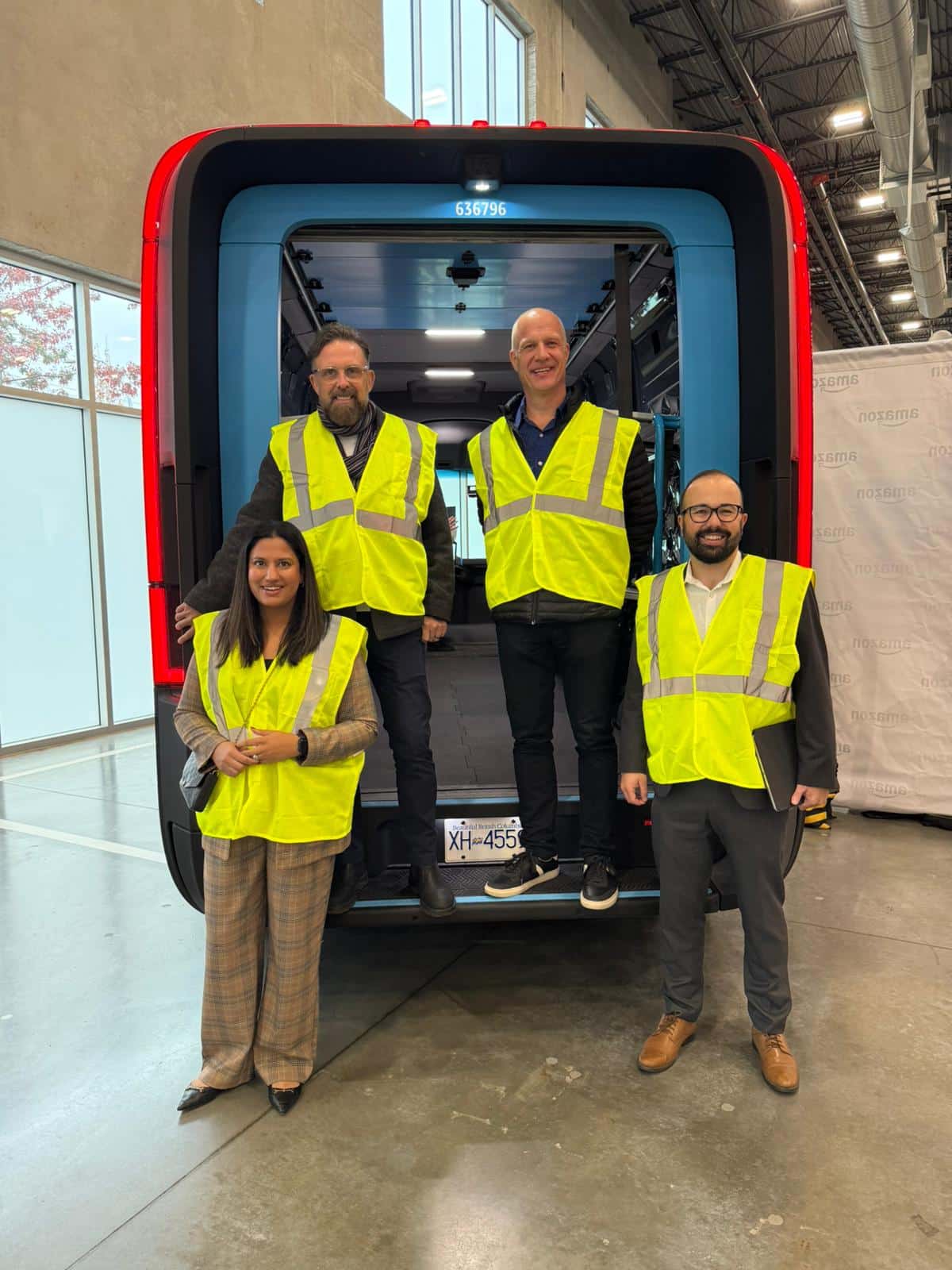 Members of the Evolution Fulfillment team check out Amazon's new sustainable electric delivery vehicles in Delta BC.